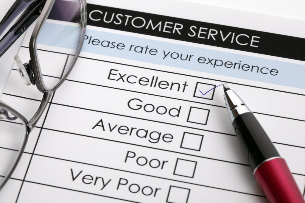 A customer service feedback form featuring a selection of ratings. A checkbox marked 'Excellent' is ticked, accompanied by a pen and glasses.